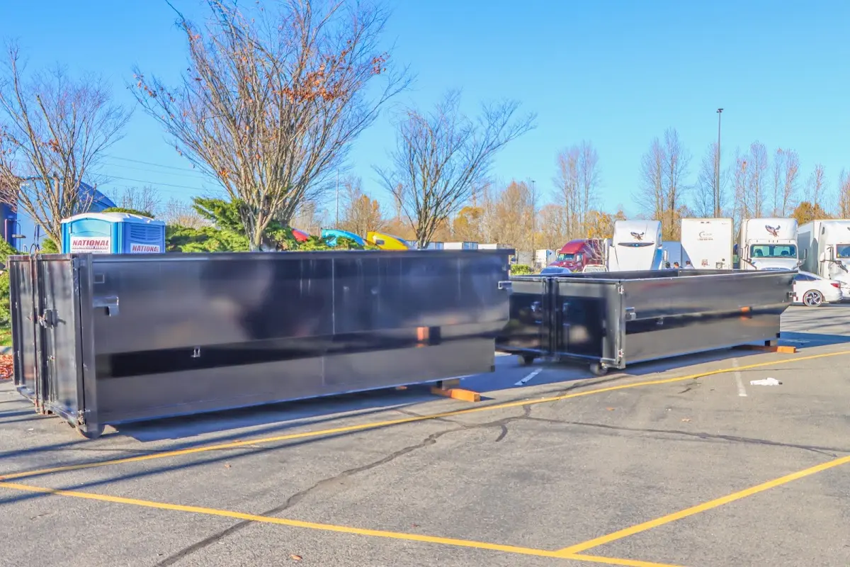 Professional dumpster rental service with roll-off container on residential driveway in Lighthouse Point